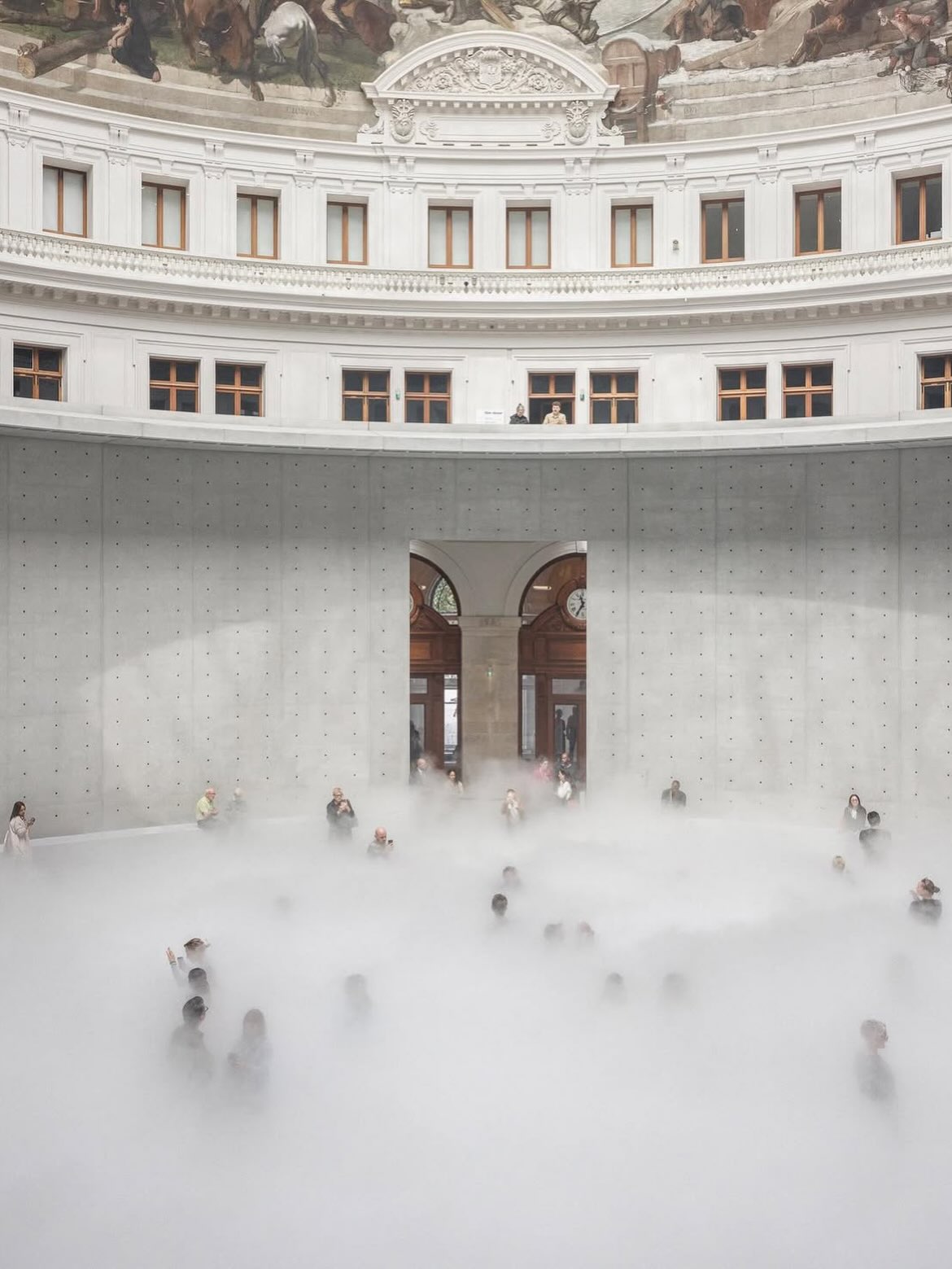 Fog fills the rotunda of the Bourse de Commerce beneath its painted dome.